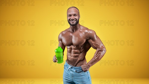 Isolated professional sportsman on a yellow background. Bodybuilding concept. Panorama. Advertising of a gym and sports nutrition.