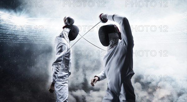 Portrait of two fencers against the backdrop of a sports arena. The concept of fencing. Duel.