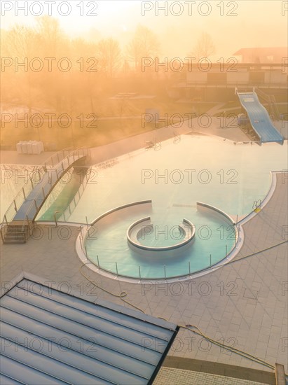 The circular pool of an outdoor swimming pool captured in the quiet atmosphere of dawn