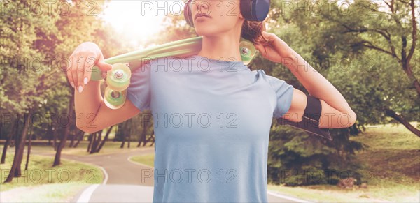 No name portrait of a girl with a skateboard. Sports lifestyle concept.