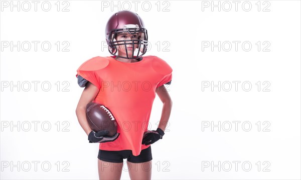 Woman in the uniform of an American football team player posing with a ball on a white background. Sports concept.