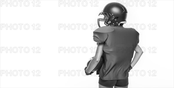 Black and white images of a sports girl in the uniform of an American football team player. Sports concept. White background.