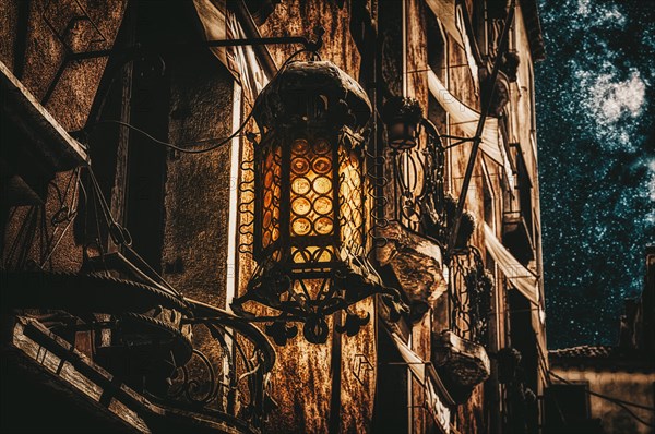 Mystical old lantern on the wall of a house. The concept of the struggle between good and evil. Education.