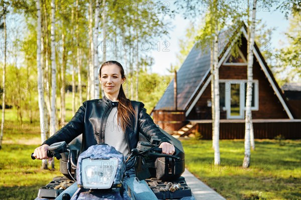 Out-of-town woman gets on quad bike to go shopping to the nearest town