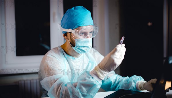 Scientist doctor in the laboratory examines the samples of the virus in vitro. vaccine development concept