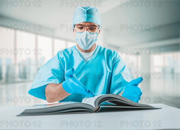 The doctor reads the textbook and points to the desired paragraph. Medicine concept.