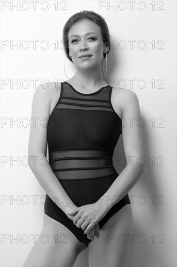 Image of a beautiful girl with a defiant make-up. Black bodysuit. White background. Beauty concept. High quality