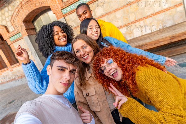 Personal perspective of a group of diverse teen friends taking a selfie in the street