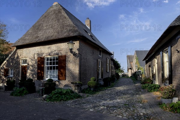 Street with brick houses and cobblestones in the small town of Bronkhorst