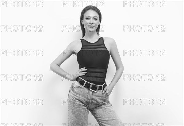 Portrait of a girl in a bodysuit and jeans. Women's underwear concept.