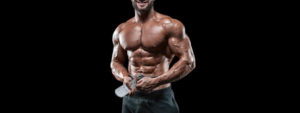 No name sexy muscular man in jeans posing on black background with a belt. Bodybuilding and fitness concept.