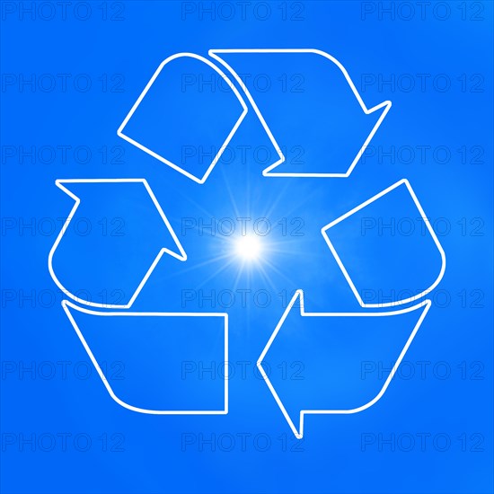 The universal recycling symbol. It is an internationally recognized symbol for recycling. Against blue sky and with the sun