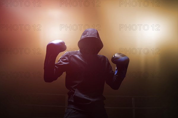 Fighter without a face is standing with his hands up. The concept of boxing