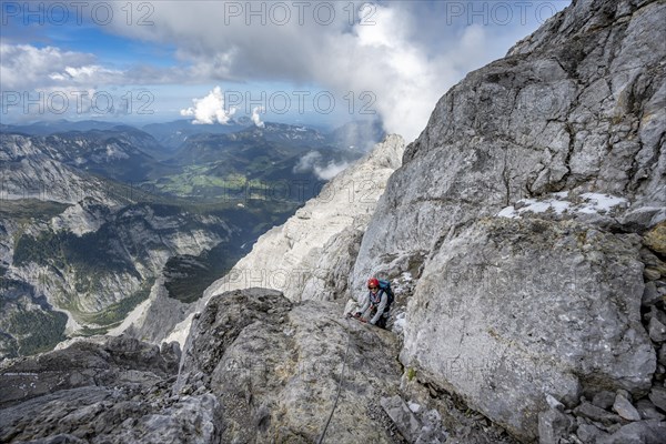 Climber on a via ferrata secured with steel rope