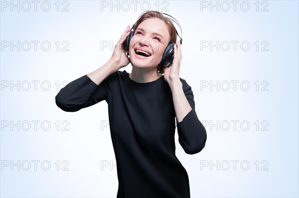 Portrait of a woman in professional headphones. White background. Dj concept.