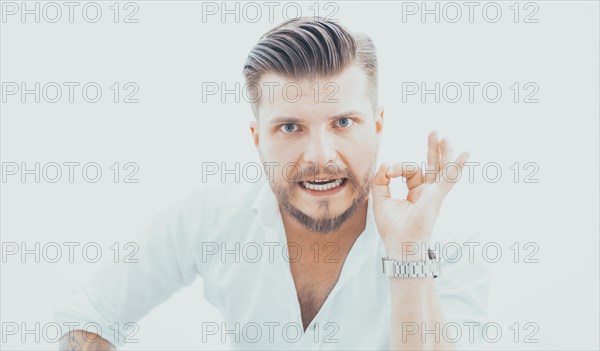 Stylish man in a shirt shows an ok sign right at the camera. The concept of success and support