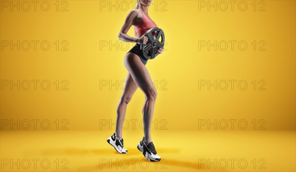 Delightful athlete posing in the studio with weights in her hands. The concept of sports