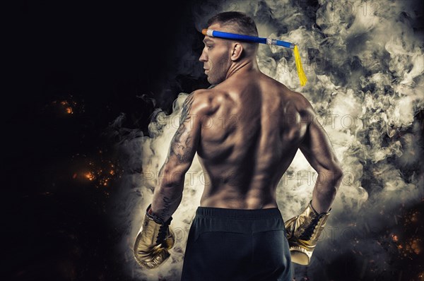 Portrait of a Thai boxer. Back view. Mixed martial arts concept. Competitions and tournaments