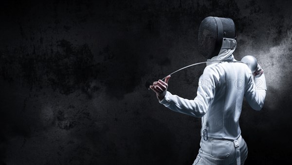 Charming girl dressed as a fencer posing with a mask and a sword. The concept of fencing. Back view.