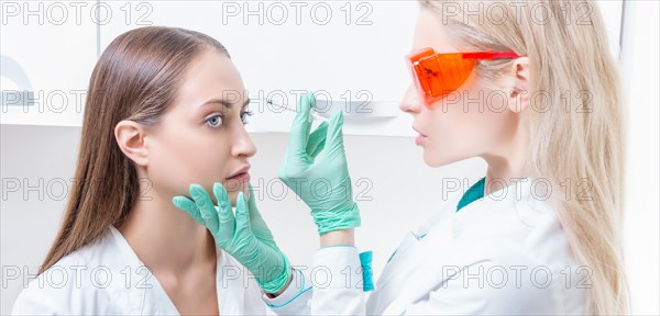 Portrait of two girls in white coats. The concept of cosmetology