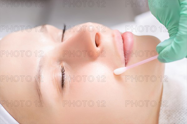 Beautiful girl gets face peeling. Skin health concept. Beauty salons.