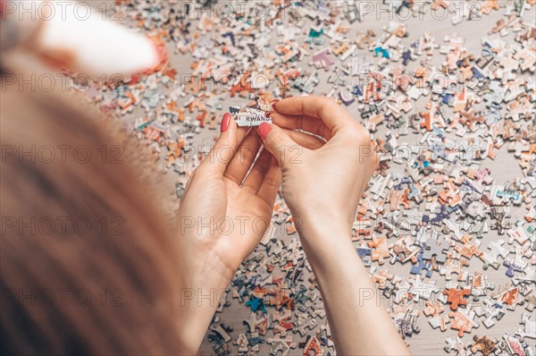 Woman arranges puzzles. Board game concept. Stay at home.