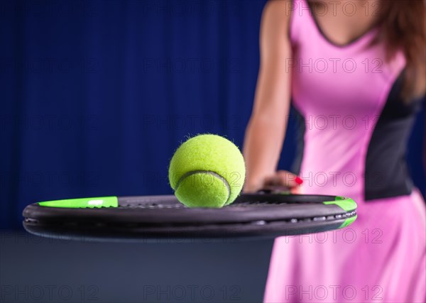 Image of a tennis ball on the background of the strings of the racket. Sports concept.