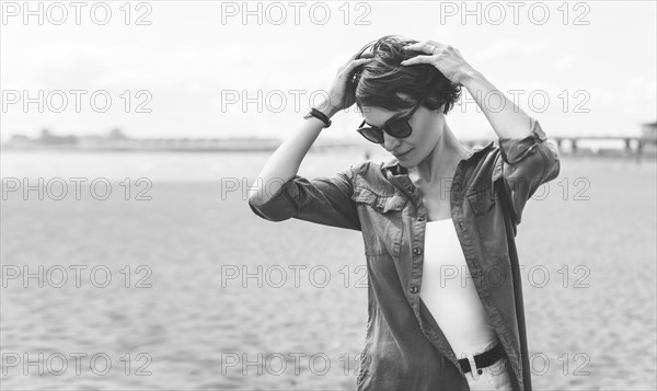 Image of a beautiful woman on the beach of the Gulf of Finland in St. Petersburg. Windy weather. Happiness