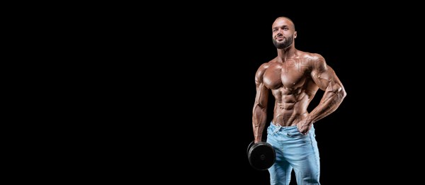 Isolated muscular man on a black background. Bodybuilding and fitness concept. Panorama.