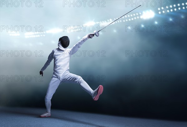 The fencer moves forward with a sword in his hand. Sport concept.