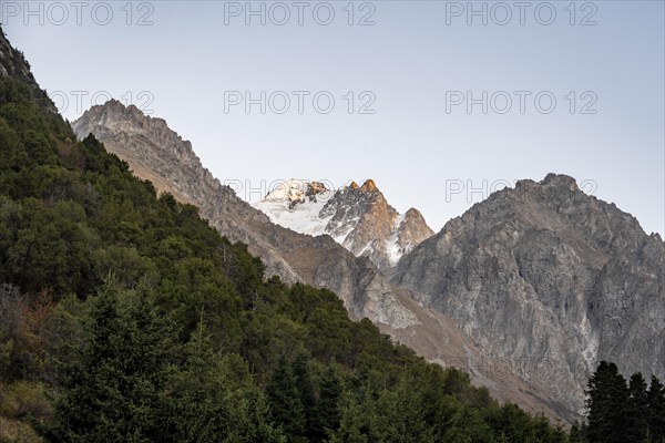 Glaciated mountain peak at sunset