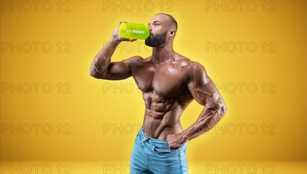 Isolated professional sportsman on a yellow background. Bodybuilding concept. Panorama. Advertising of a gym and sports nutrition.