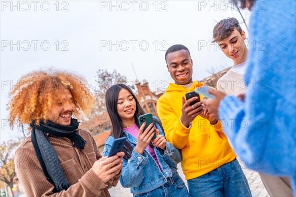 Dynamic shot of multi-ethnic friends using phone in the city