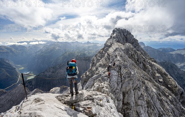 Climber on a via ferrata secured with steel rope