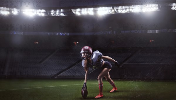 Image of a girl in the uniform of an American football team player preparing to play the ball at the stadium. Sports concept.