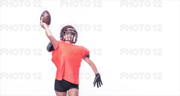 Woman in the uniform of an American football team player throws the ball. Sports concept.