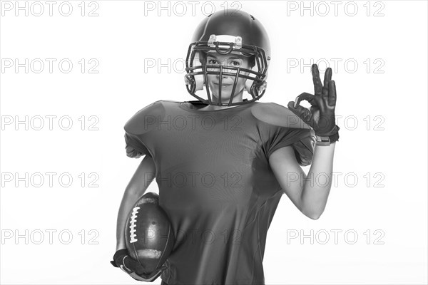 Black and white images of a sports girl in the uniform of an American football team player. Sports concept. White background.