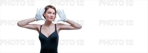 Surprised beautiful young woman in white gloves posing in the studio on a white background.