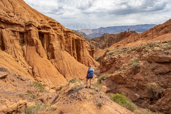 Climber in a canyon with a dry stream bed