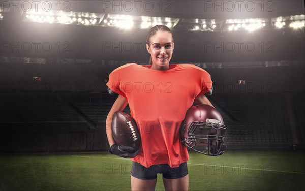 Iimage of a girl at the stadium in the uniform of an American football team player. Sports concept.