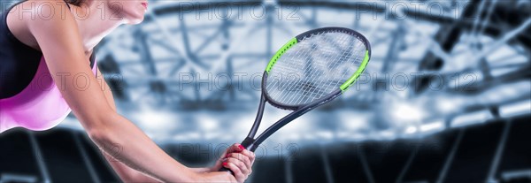 Portrait of a tennis player in a pink dress against the background of a sports arena.