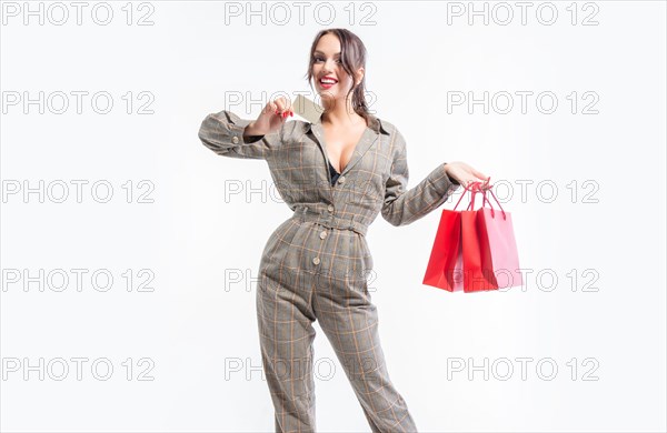 Sexy girl posing with a discount card and red bags. Concept Shopping on Black Friday. White background.