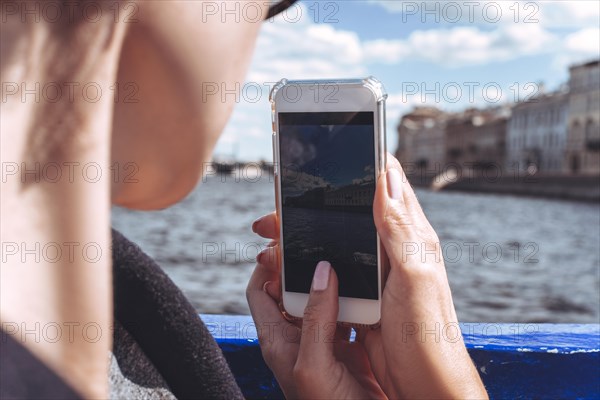 Saint Petersburg Russia 19.07.2021. Portrait of a woman taking pictures of St. Petersburg during a boat trip. Tourism concept