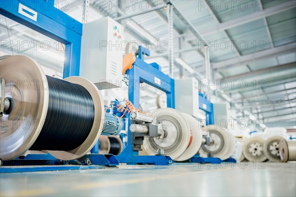 Industrial production of fiber optic cable for telecommunication systems. Manufacturing of modern fiberglass and fiber optic cables at the factory