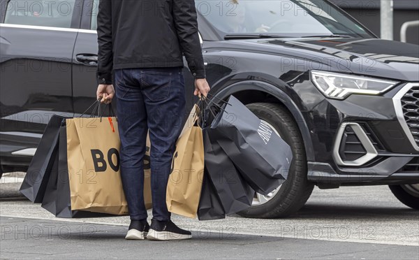 Consumer tourist lugging shopping bags