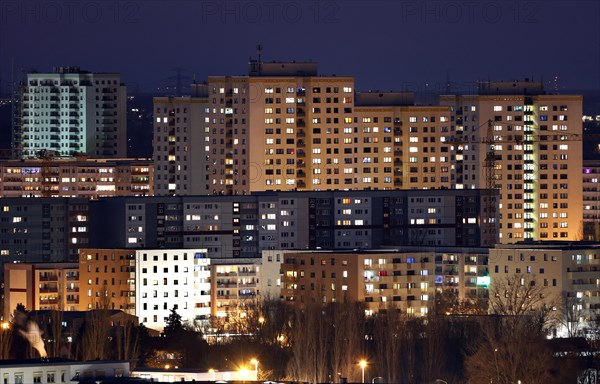 View in the evening at blue hour of high-rise buildings and apartment blocks with rental flats and condominiums in the Berlin district of Marzahn-Hellersdorf