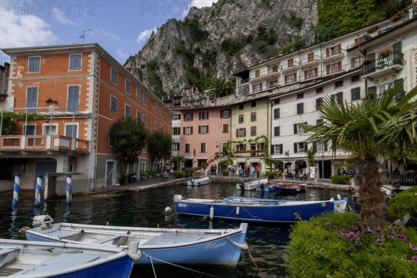 Houses and fishing boats in the old harbour of Limone sul Garda