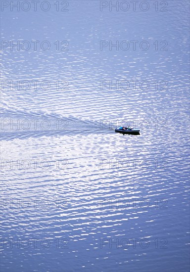 Elevated view of a leisure boat on the Edersee with cloud reflection on the water surface