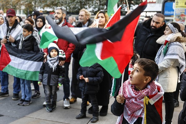 A young boy waves a Palestinian flag during the demonstration Freedom for the people of Gaza