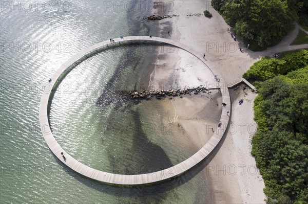 An aerial view shows people walking on the infinite bridge. The bridge is a work of art built by Sculpture by the Sea